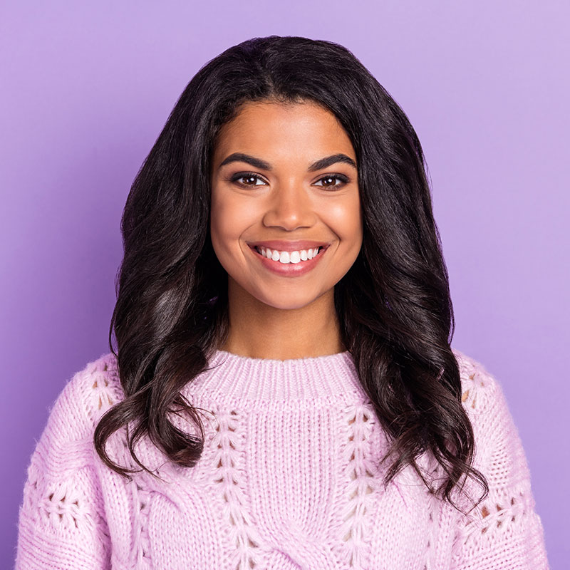 A young lady smiling while listening to overhead music by Spectrio in the USA