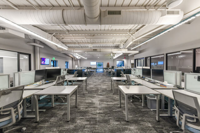 interior modern workplace with desks down a hall