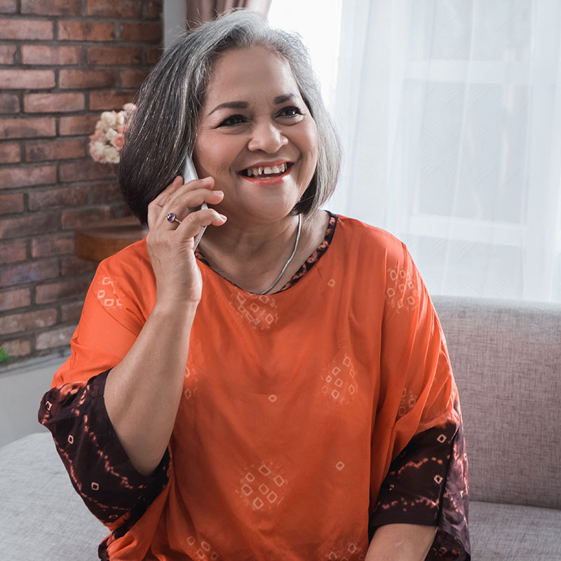 A woman on a call listening to an on-hold message by Spectrio in the USA