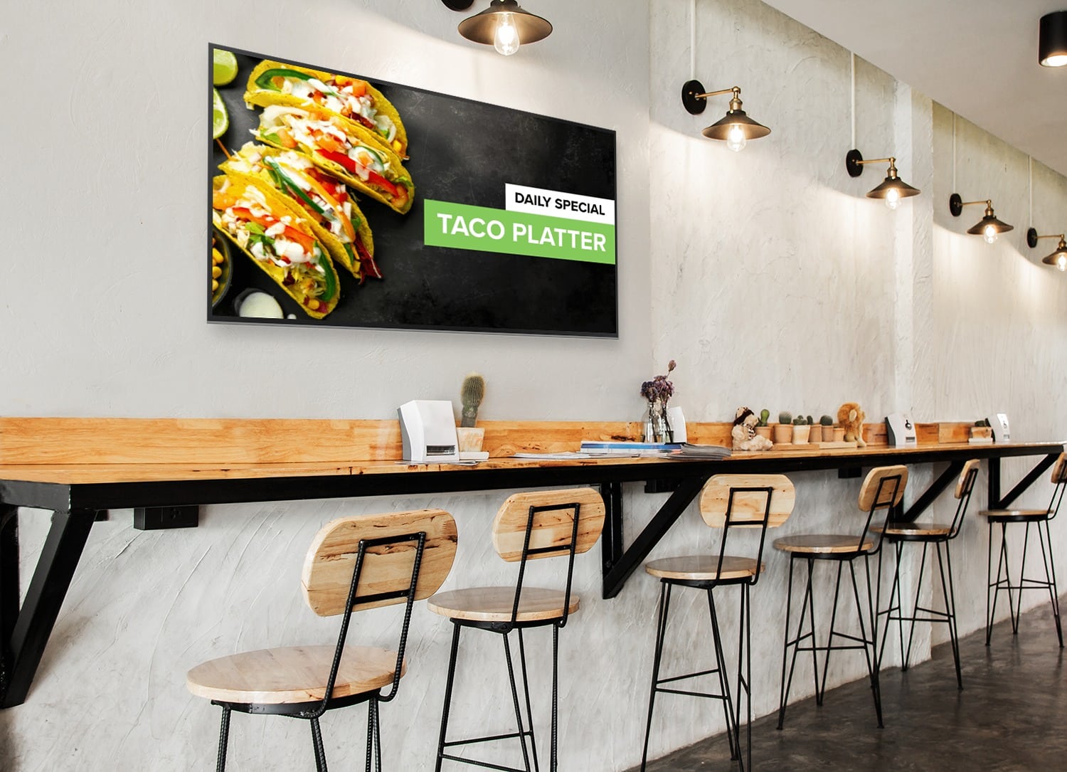A stunning and sleek digital menu board hanging above bar seating in a restaurant