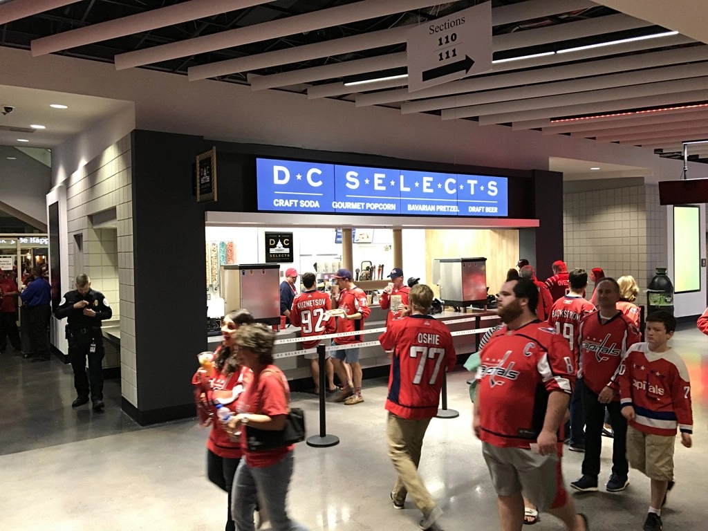 People standing near Capital One Arena concession stands by Spectrio in the USA